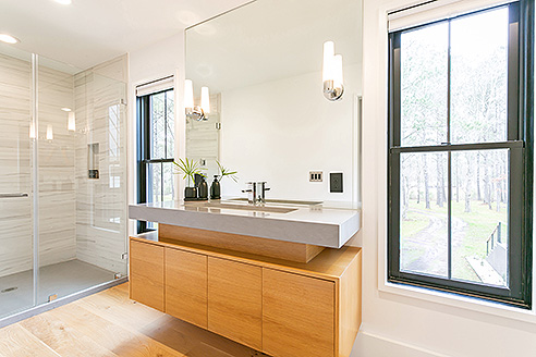 Modern bathroom with wooden cabinets